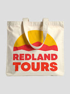 Tote bag naturale Redland Tours con grafica sole giallo e dune rosse.