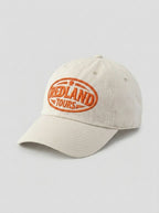 Cappellino beige Redland Tours con logo ovale ricamato arancio.