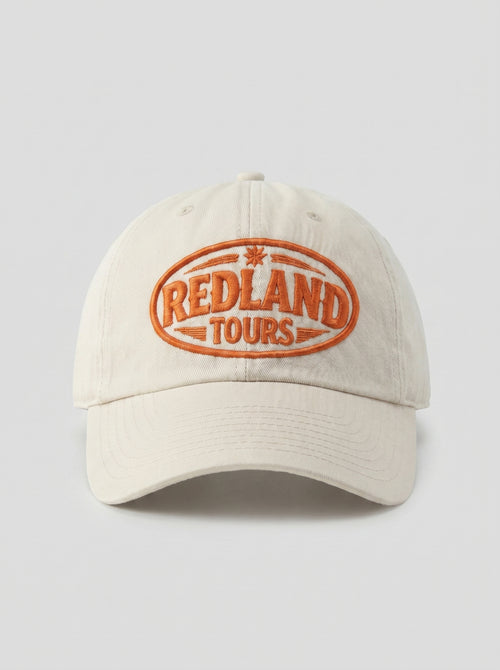 Cappellino beige Redland Tours con logo ovale ricamato arancio.